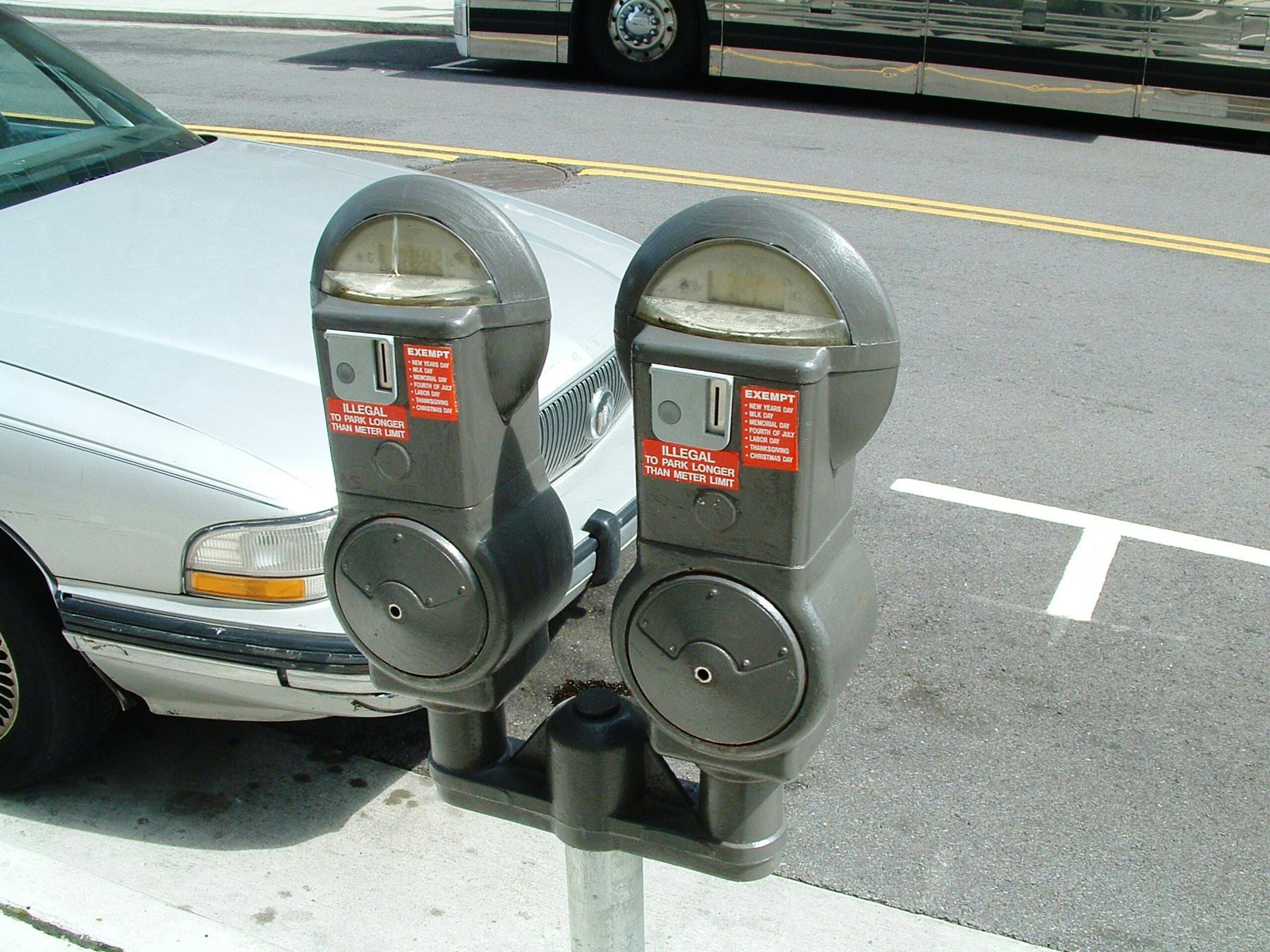 two parking meters on the side of the road